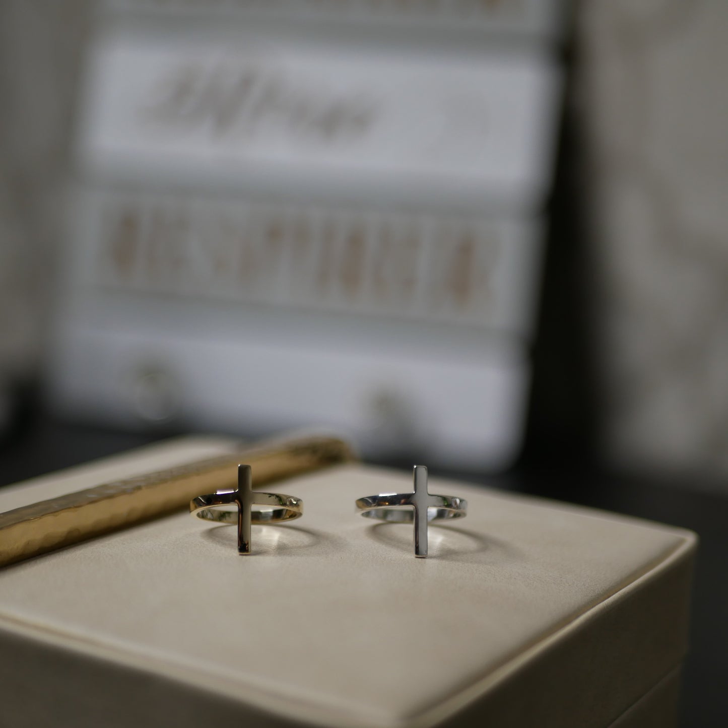Two ring shaped like a cross beside of each other on the top of a box