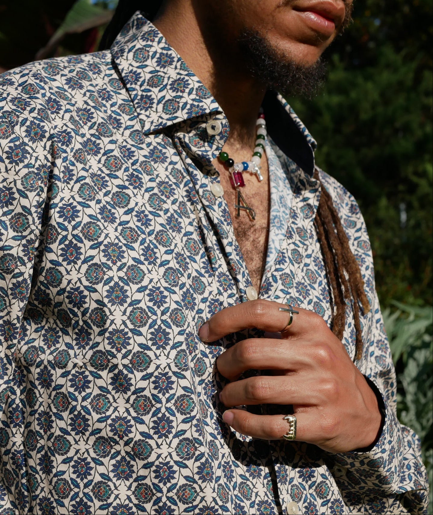 Black man in african shirt wearing Attale jewels