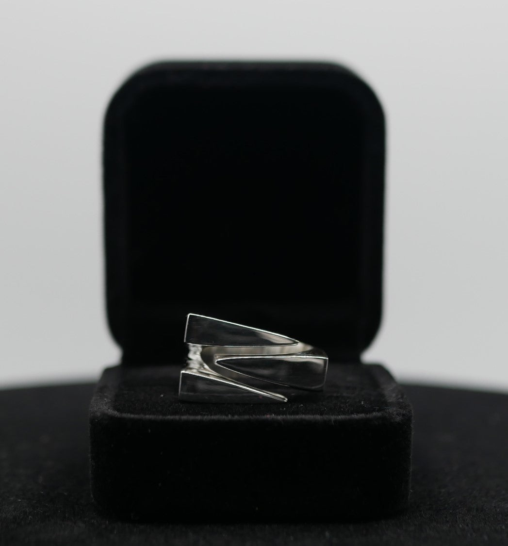A Silver claw ring made by Attale jewels in a jewelry box